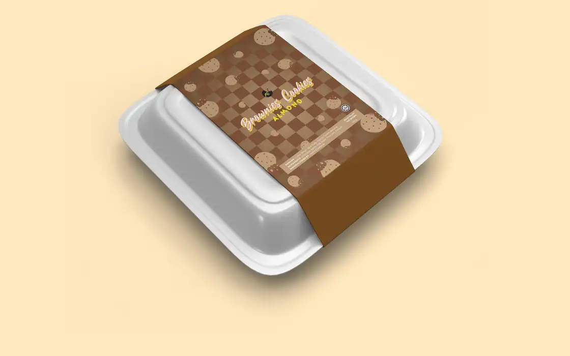 Brownies-and-cookies sleeve label wrapped around a white styrofoam takeaway container on a cream ground